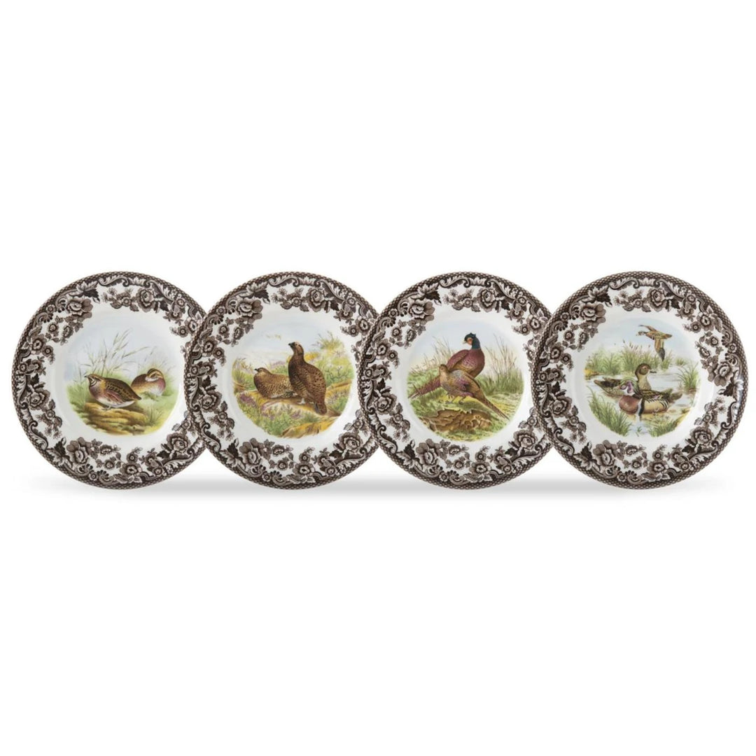 Four decorative plates with bird illustrations on a white background