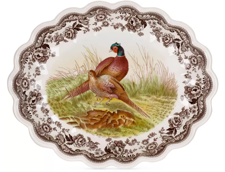 A fluted oval dish with a countryside pheasant and floral design.