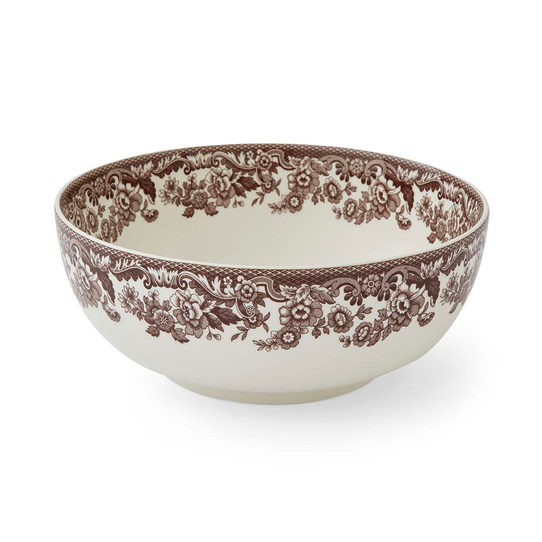 Decorative ceramic bowl with brown floral pattern on a white background