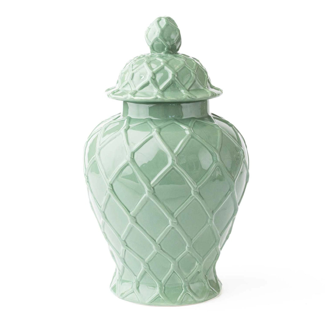 Mint green ceramic jar with lattice design and spherical lid on a white background