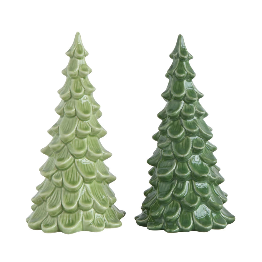 Two green ceramic Christmas tree figurines on a white background