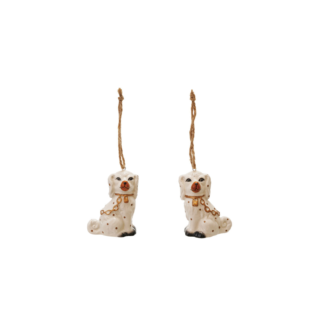 Two ceramic dog ornaments with gold chains on a white background