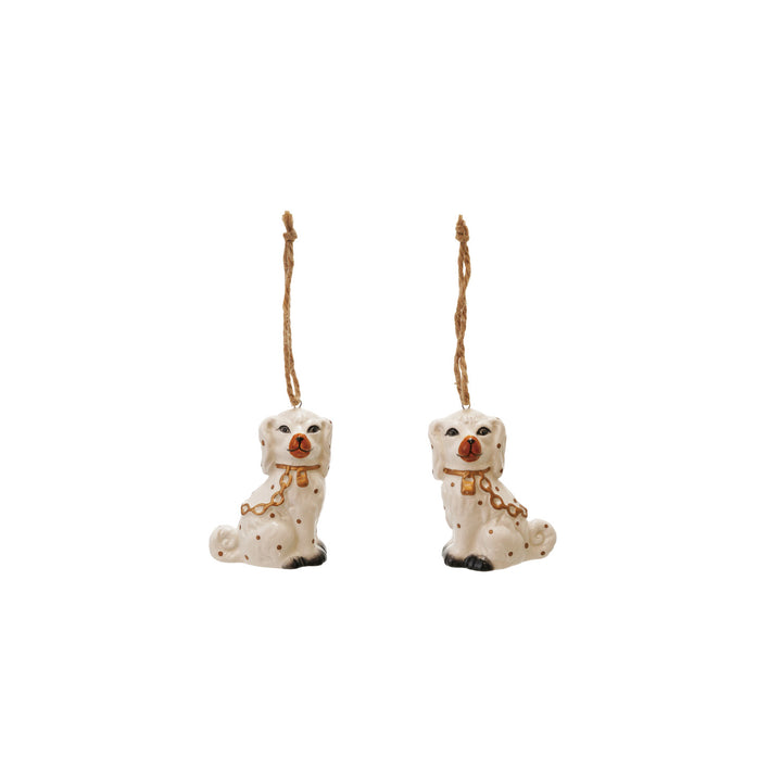 Two ceramic dog ornaments with gold chains on a white background