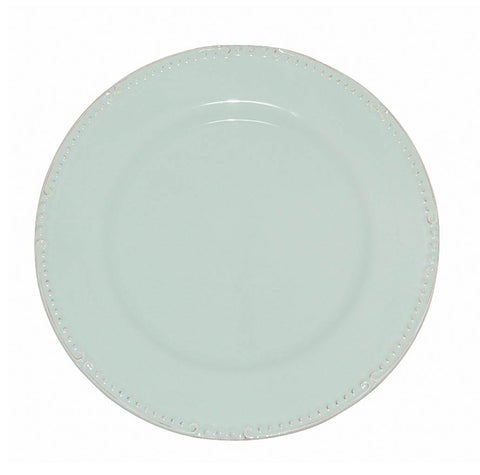 A round ceramic charger plate in ice blue color with embossed details around the edge.