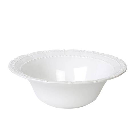 A white ceramic serving bowl with a decorative pattern around the rim.
