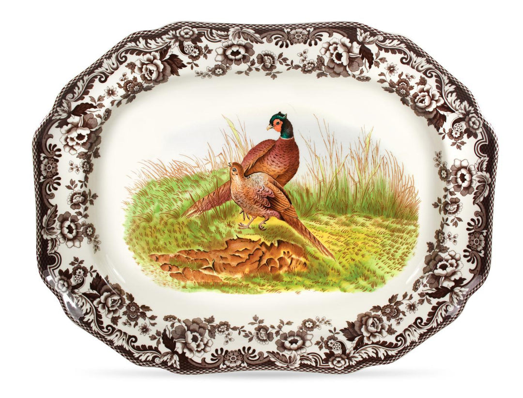 An octagonal porcelain platter with a detailed painting of a pheasant in a natural setting, surrounded by a brown patterned rim.