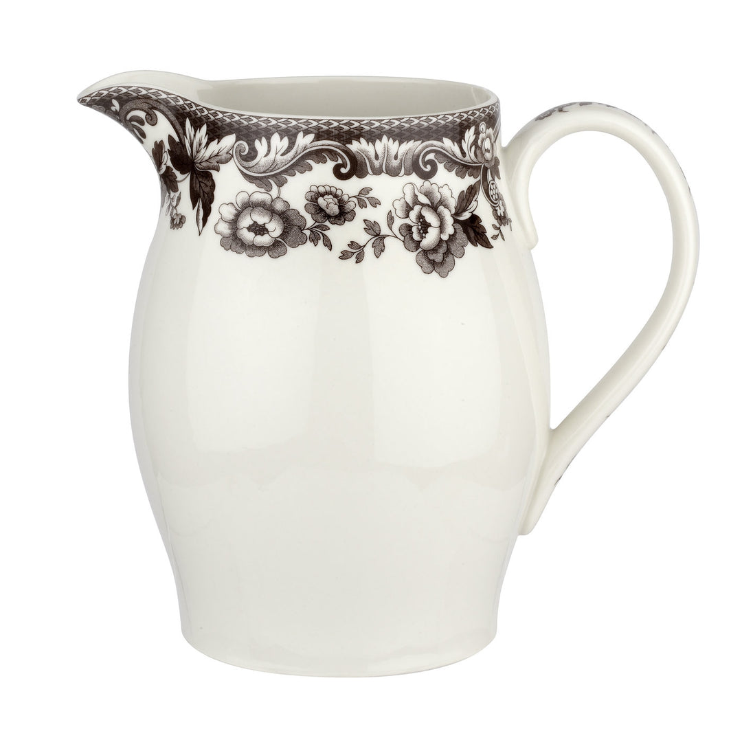A white porcelain pitcher with a brown floral border design.