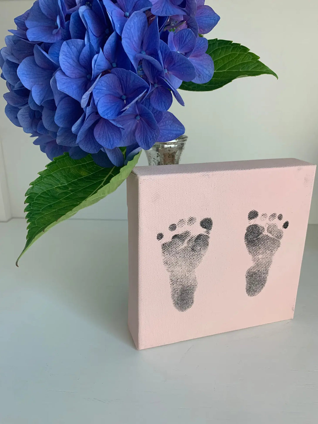 5x5 pink canvas with stamped footprint