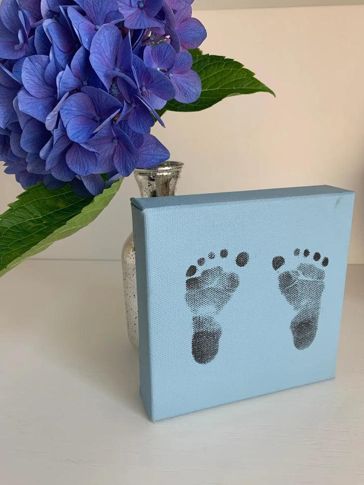 blue 5x5 canvas with stamped footprint