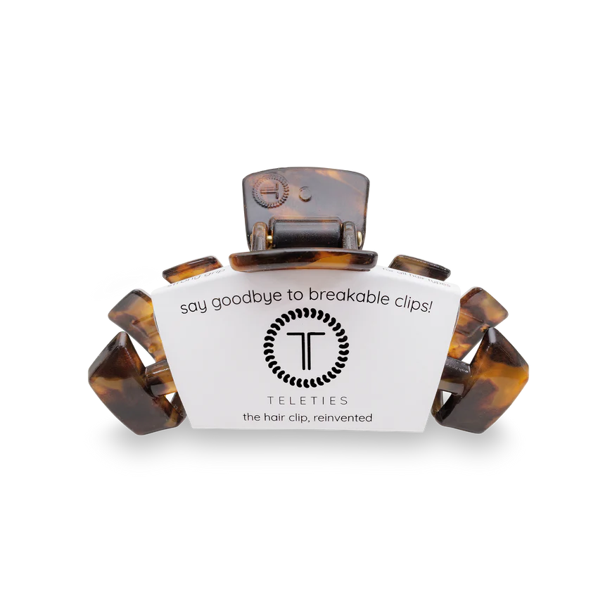 A Teleties hair clip in a tortoiseshell pattern, shown with its white branded cardboard packaging on a clean white background.