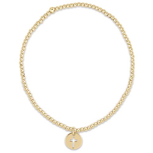CLASSIC GOLD 2MM BEAD BRACELET WITH SMALL GOLD BLESSED CHARM WHICH IS A GOLD DISC WITH CROSS CUT OUT IN CENTER