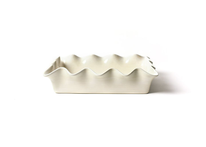 A white ceramic casserole dish with a ruffled design, isolated on a white background.