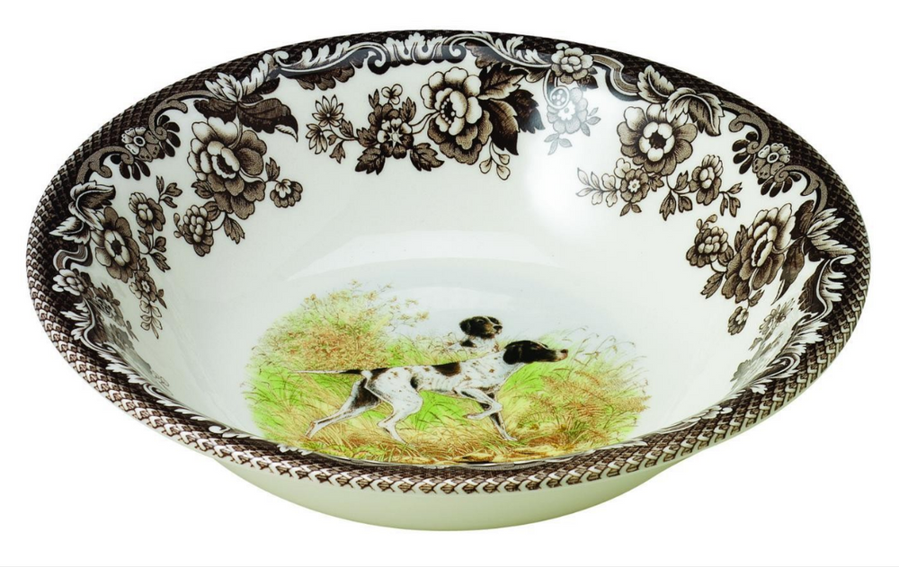 A ceramic cereal bowl with a floral and animal pattern, featuring a black lab in the center.