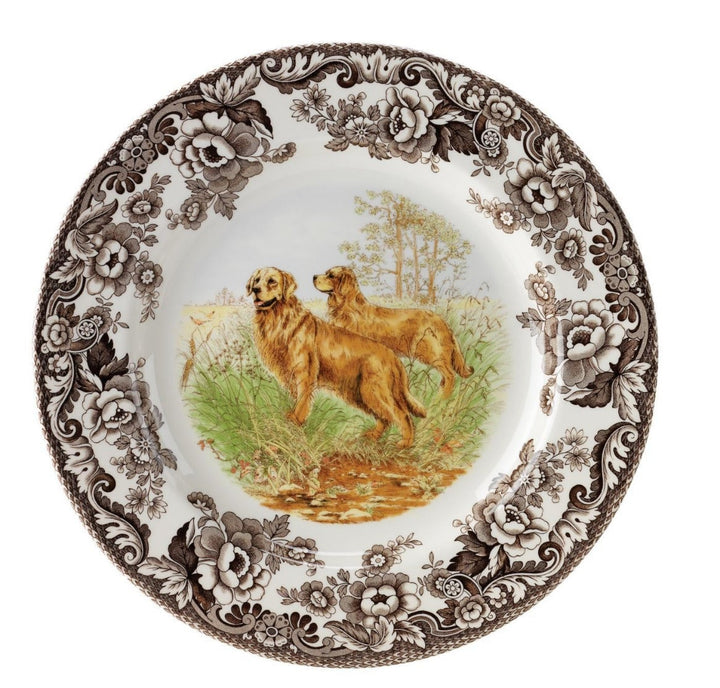 A Spode Woodland Salad Plate featuring an illustration of a black lab dog in a field with floral and scroll designs around the border.