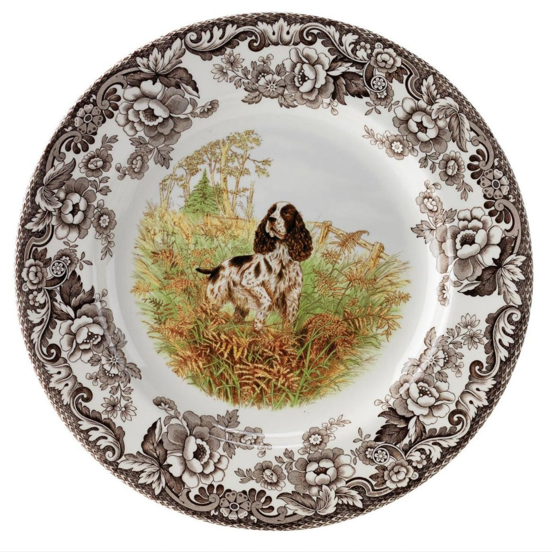 A round porcelain salad plate with a detailed woodland animal illustration in the center, surrounded by a floral pattern.